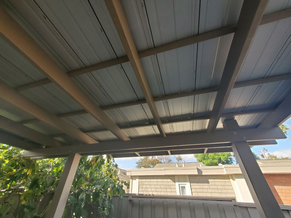 Custom pergola with solid metal roofing