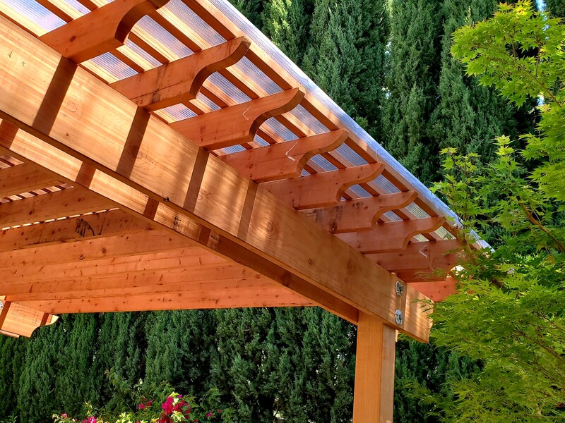 Redwood pergola with poly-carbonate roofing in a San Jose backyard